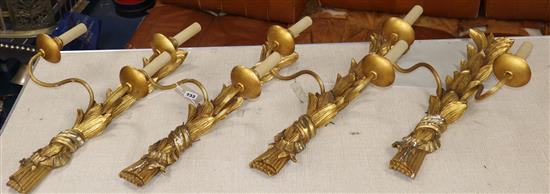 A set of four gilt plaster two branch wall sconces